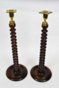 Pair of barley twist oak candlesticks with brass sconces, 50cm high (2)