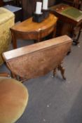 Victorian burr walnut veneered drop leaf table of oval form raised on turned columns with outswept