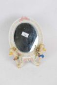 Small oval mirror, Continental porcelain framed decorated with two cherubs, blue factory mark to