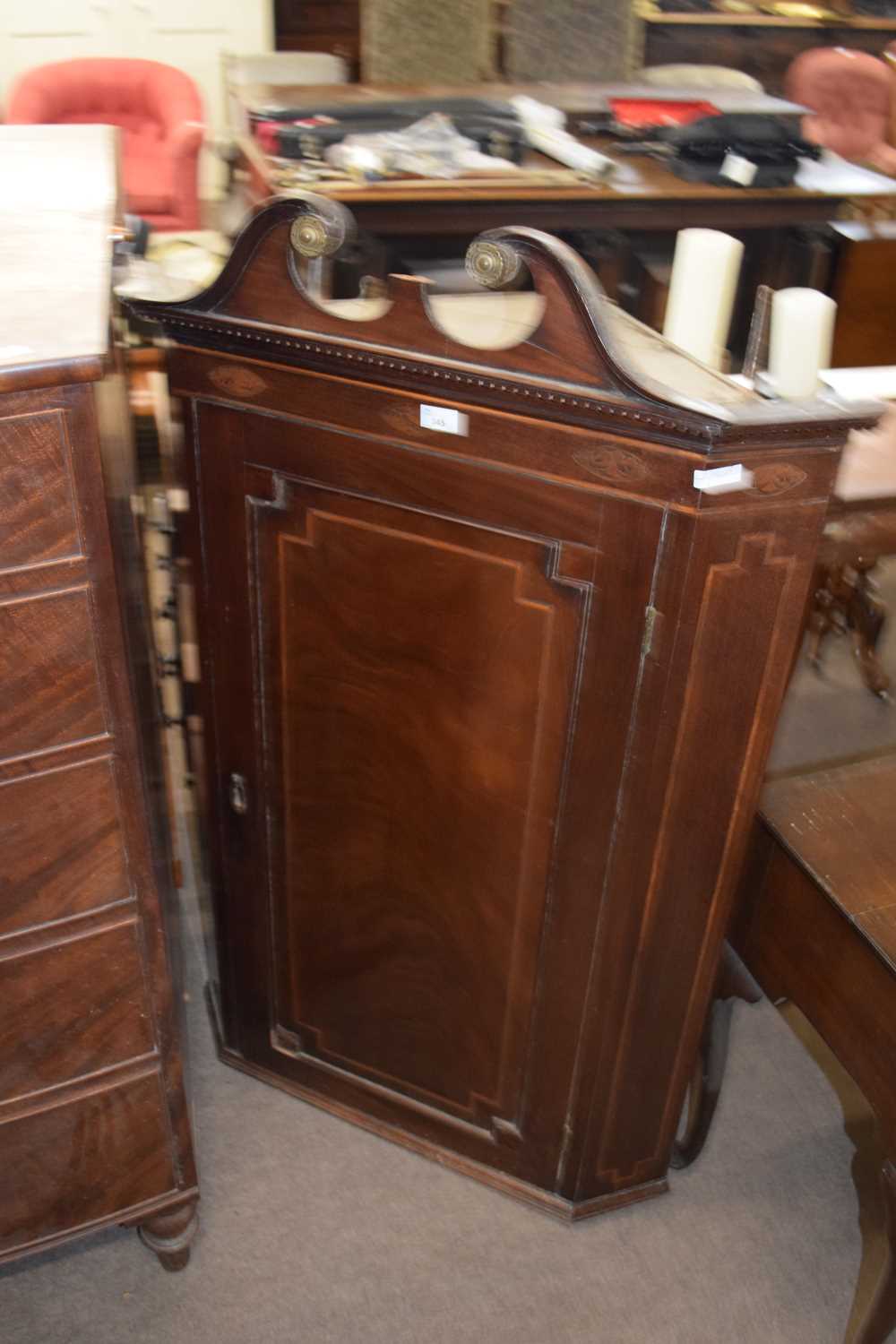 Georgian mahogany wall mounted corner cabinet with broken arch pediment over a single panelled