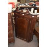 Georgian mahogany wall mounted corner cabinet with broken arch pediment over a single panelled