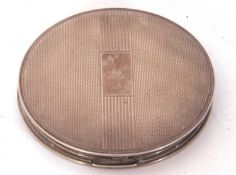 George VI circular compact with banded engine turned decoration having internal mirror and powder