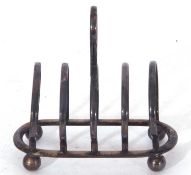 Small George V toast rack, five hooped bars to an oval base with four ball feet, central ringlet