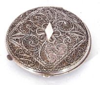 White metal powder compact of hinged circular form, decorated with filigree work and fitted with