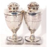 Pair of George III silver peppers of urn form, pull off pierced lids and panelled bodies to a square