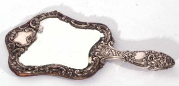 Late Victorian silver mounted dressing table hand mirror, the bevelled mirror surrounded by