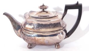 George III silver tea pot of squat oval form, banded body with angular ebonised loop handle,