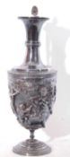 Silver plated ewer with a Bacchanalian decorated body, angular handle to a hinged lid, the