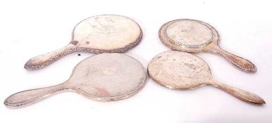 Four silver hallmarked backed dressing table mirrors, various dates and makers (4)