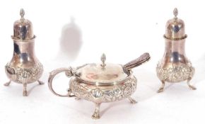 George V three piece condiment set of circular baluster form, heavily embossed and engraved with