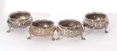 Set of four Victorian circular salts with shaped and gadrooned rim, floral and foliate embossed