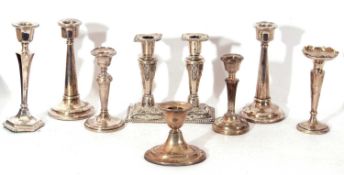 Mixed Lot: silver candlesticks including a pair of embossed examples, Birmingham 1900, and six