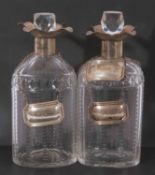 Pair of late Victorian silver and glass spirit decanters, the oval shaped glass bodies with