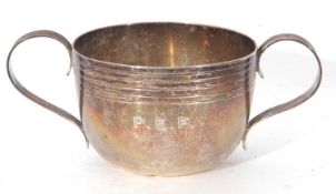 Irish silver twin handled bowl of circular form, the top section and handles with reeded detail, the
