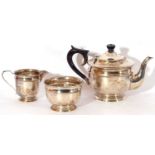George VI silver three piece tea set of slight circular compressed form, comprising tea pot, milk