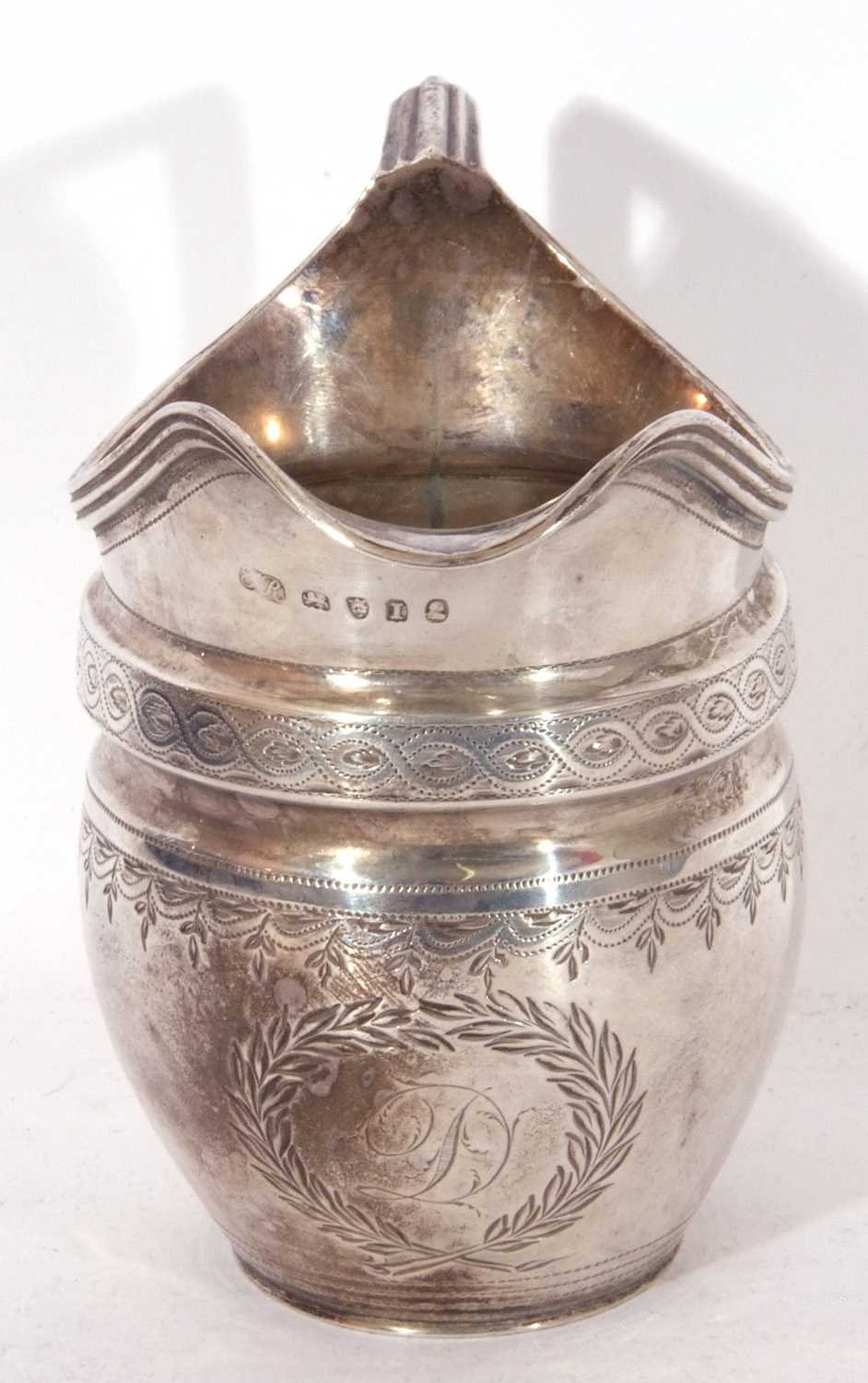 George III helmet cream jug of waisted oval form, bright cut and punched decoration, reeded rim - Image 3 of 5