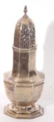 Large Edwardian caster of octagonal baluster form having pierced domed lid with urn finial, 20cm