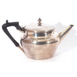 George V silver bachelor tea pot of bullet shape, plain form, hinged lid with urn finial, a capped