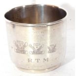 George V silver mug of plain circular form with an angular handle, engraved and chased with three