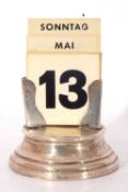 George V silver encased based perpetual calendar with cards, the months in German, 7cm diam base,