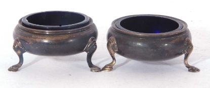 Pair of 18th century silver three footed salts of circular form fitted with blue glass liners, marks
