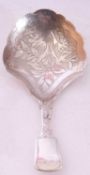 William IV silver Fiddle pattern caddy spoon, the bowl with engraved floral decoration and frilled