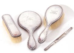 Edwardian three piece silver backed dressing table set with bellflower embossed edges, each
