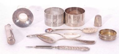 Mixed Lot: two napkin rings, souvenir tea spoon with enamelled finial, decanter neck, bottle top,