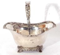 Antique silver bon-bon basket of oval form with applied scroll edge with pierced swing handle,