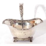 Antique silver bon-bon basket of oval form with applied scroll edge with pierced swing handle,