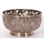Chinese white metal bowl, plain circular pierced form onto a plain collet foot, the body embellished