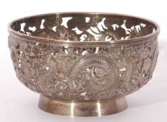 Chinese white metal bowl, plain circular pierced form onto a plain collet foot, the body embellished