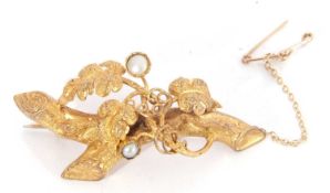 Vintage gilt metal brooch, a vine and leaf design highlighted with two small cultured pearls, 50mm