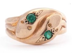 9ct gold double headed serpent ring, the heads each set with a round cut green stone, the shank a