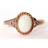 9ct gold and white opal ring, the cabochon opal bezel set within a rope twist surround, Birmingham