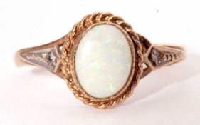 9ct gold and white opal ring, the cabochon opal bezel set within a rope twist surround, Birmingham