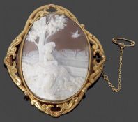 Victorian carved shell cameo brooch, oval form, depicting a shepherdess, in a decorative gilt