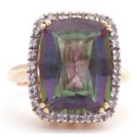 Mystic topaz and diamond ring with a rectangular shaped mystic topaz, four claw set and raised above