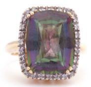 Mystic topaz and diamond ring with a rectangular shaped mystic topaz, four claw set and raised above