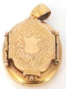 Victorian oval double locket, the engraved door opens to a hidden hinged compartment, g/w 12.6gms (