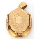 Victorian oval double locket, the engraved door opens to a hidden hinged compartment, g/w 12.6gms (