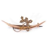 9ct gold and seed pearl brooch, plain polished curved bar applied with a scrolling leaf and vine