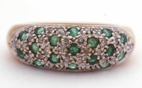 Modern 9ct gold emerald and diamond cluster ring set with 17 small round cut emeralds and