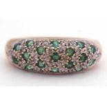 Modern 9ct gold emerald and diamond cluster ring set with 17 small round cut emeralds and