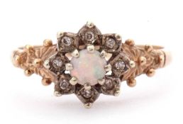 9ct gold opal and paste set cluster ring, the round cabochon opal raised above eight small pastes
