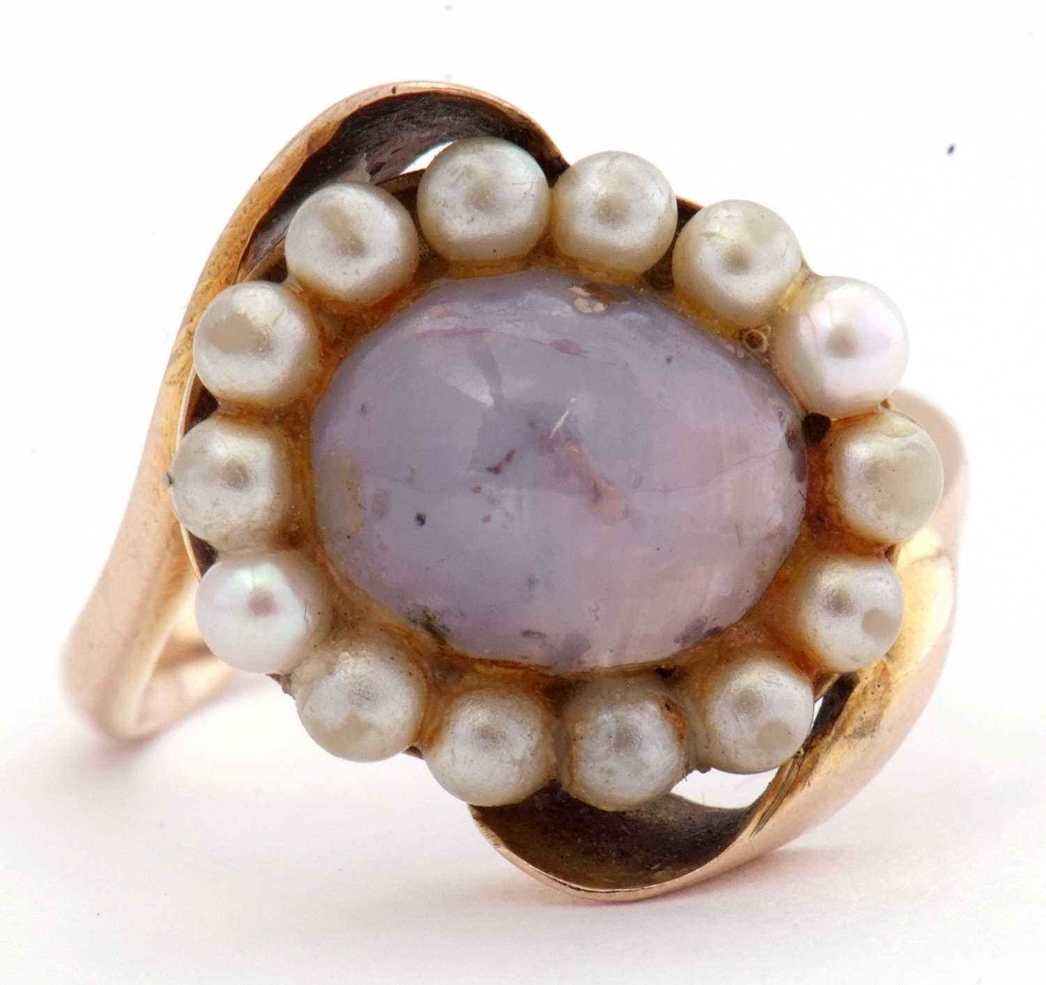 Modern moonstone and seed pearl ring, the cabochon moonstone within a seed pearl surround, between