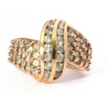 Modern 10k stamped ring, a stylised design set throughout with small light green coloured stones,