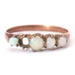 Four stone opal ring featuring four graduated round opal cabochons (one stone missing), all in an