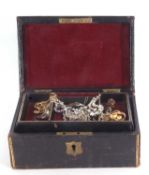 Victorian leather jewel box and contents to include small quantity of costume brooches, pendants