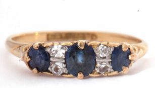 Sapphire and diamond seven stone ring, a design with three graduated oval faceted sapphires,